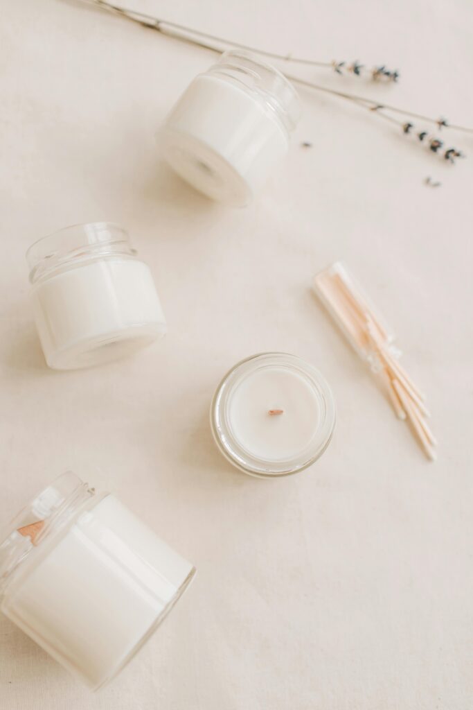 Elegant minimalist arrangement with scented candles and dried lavender on a soft background.