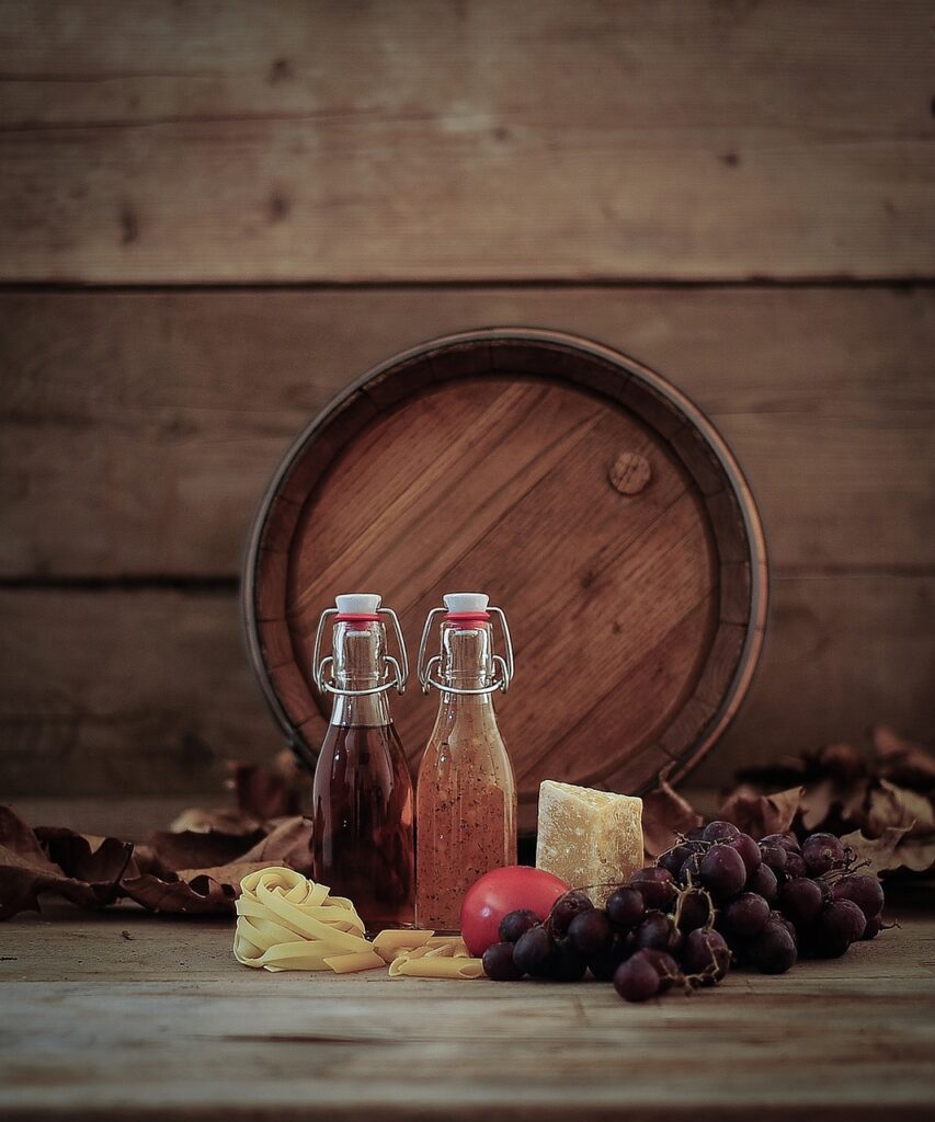 wine barrel, grapes, oil bottle