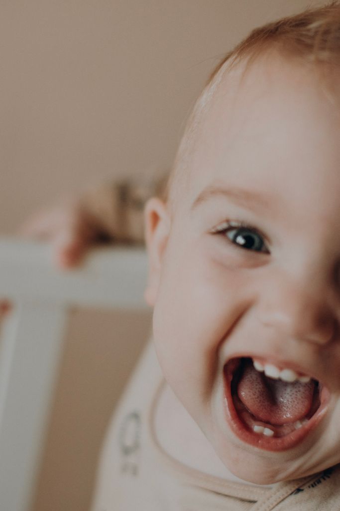 Adorable baby smiling widely in a heartwarming close-up shot.
